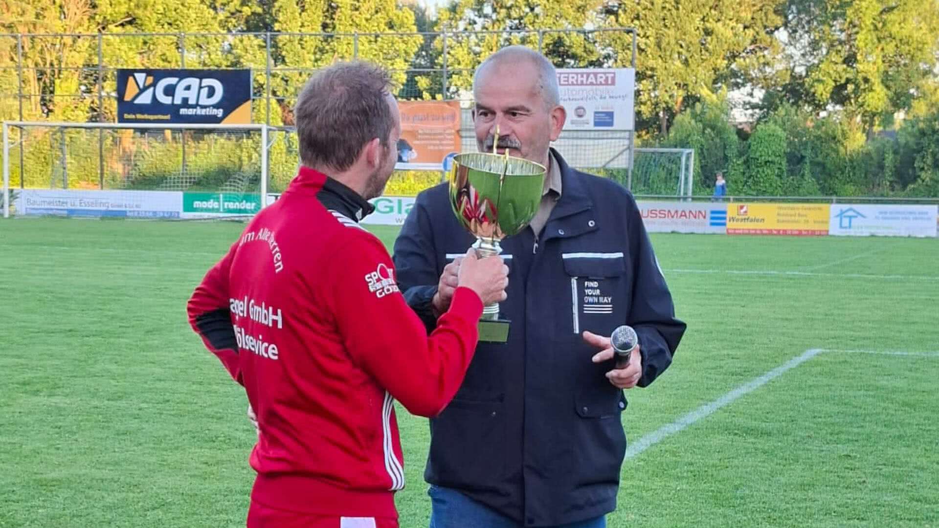 Manfred Nieland übergibt den Ü50-Wanderpokal an den Kapitän der Ü50-Mannschaft der SG Coesfeld